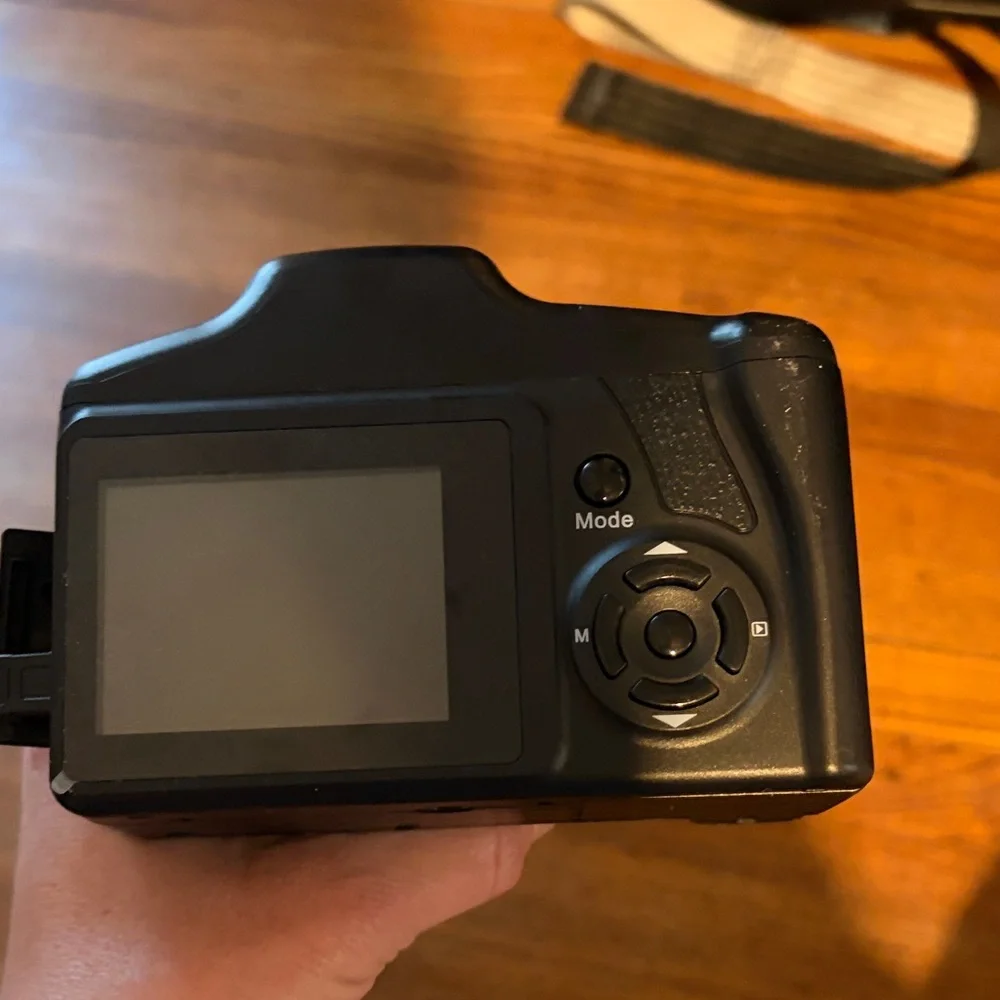 Black Compact Digital Camera with Lens Cap and SD Card